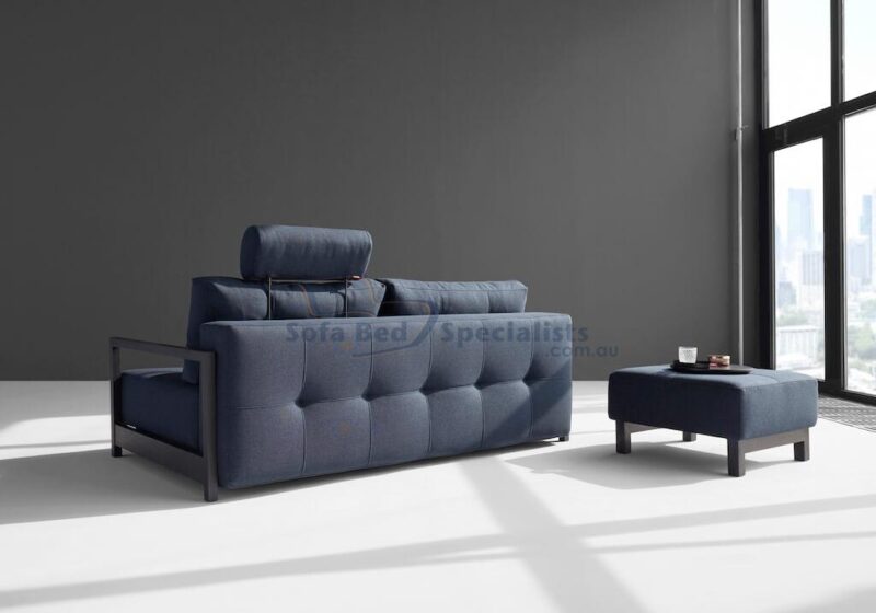 Sophia Sofa Bed from behind next to matching Pouf opened up in a Grey Room with a big window