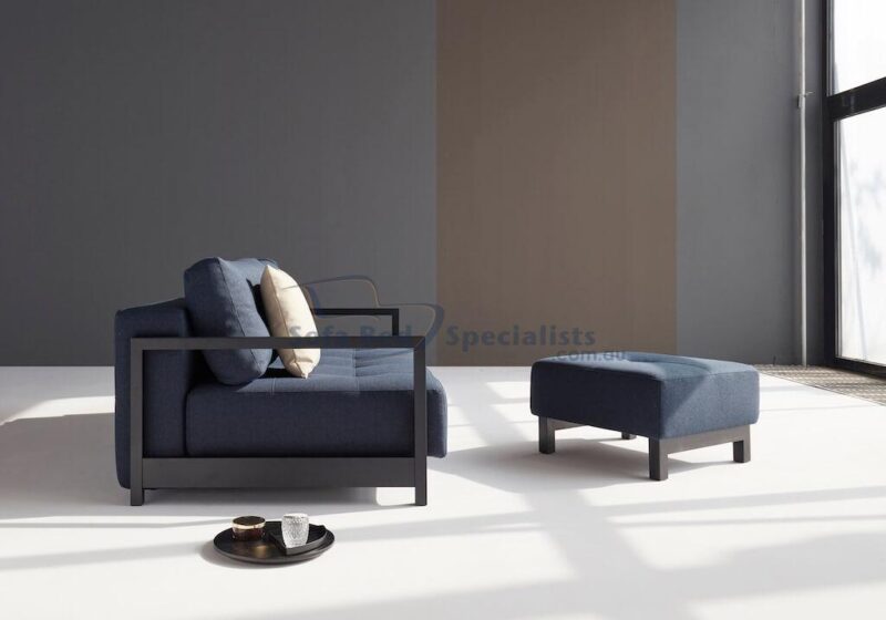 Sophia Sofa Bed from the side next to matching Pouf opened up in a Grey Room with a big window